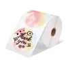 Roll of stickers with floral design and text on a white background